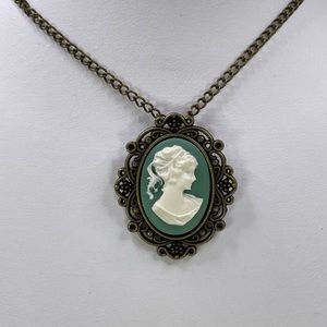Green cameo necklace with bronze colored filigree and chain